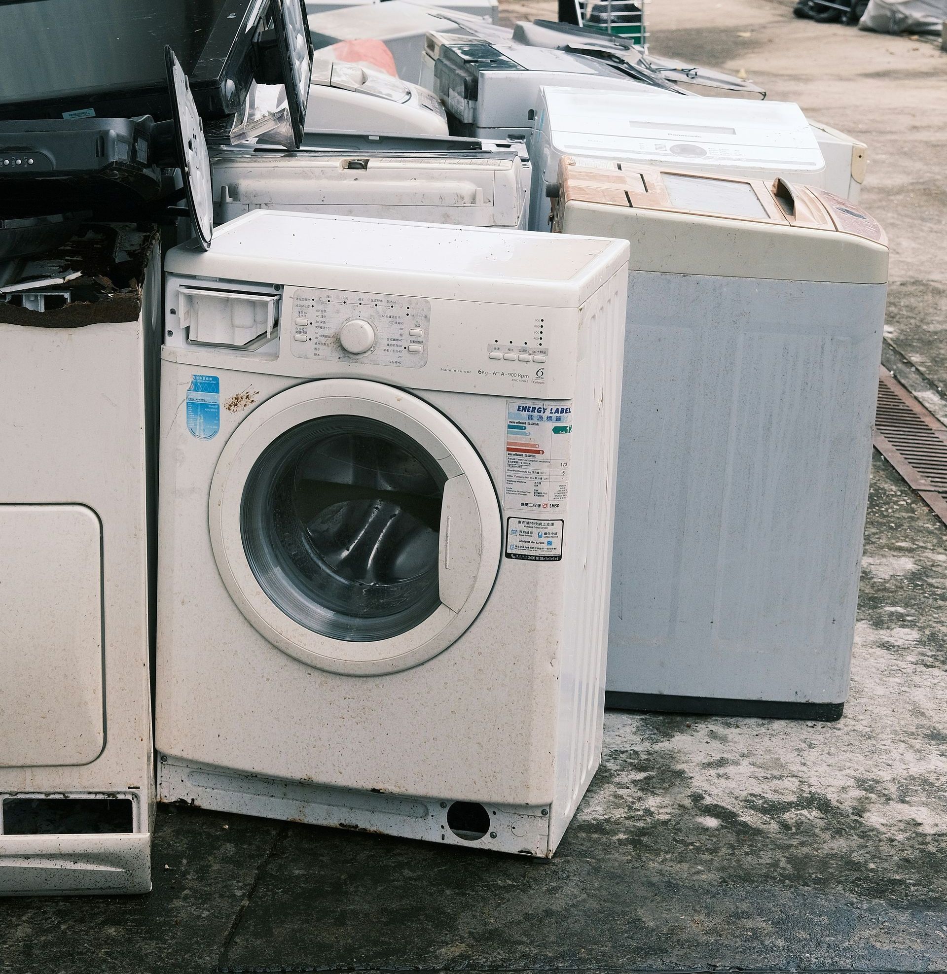 a pile of washing machines sitting next to each other
